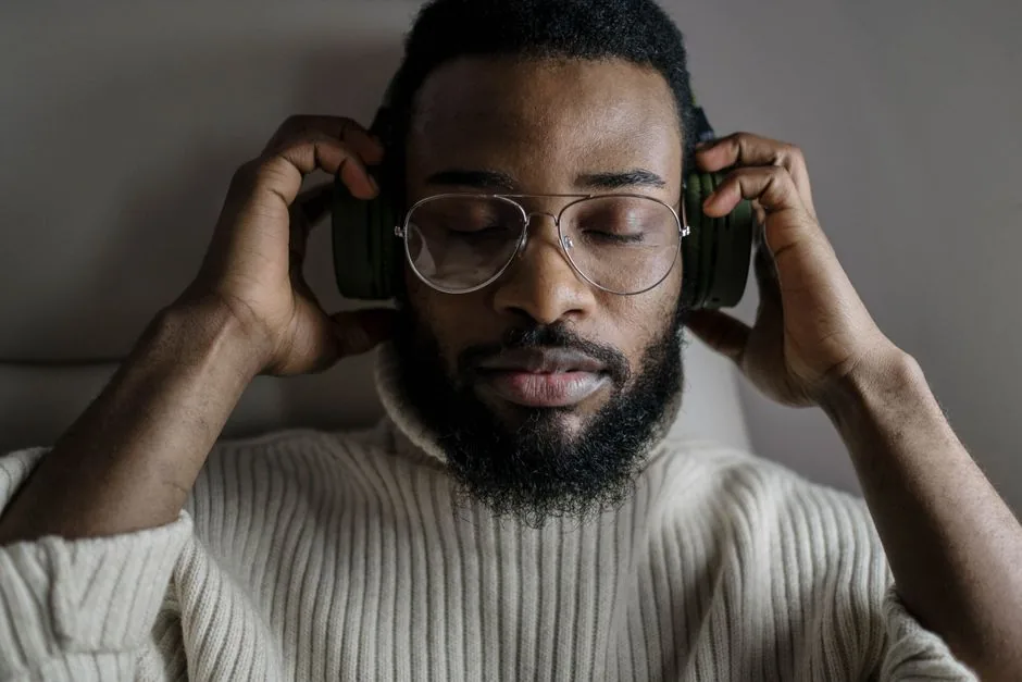 Close-up of a man with headphones on, eyes closed